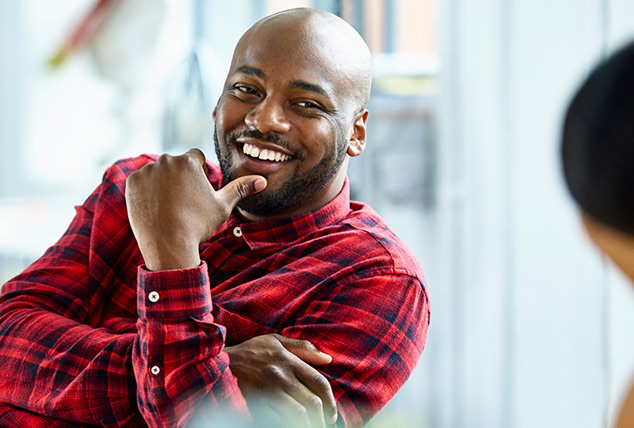 A man smiles at a co-worker